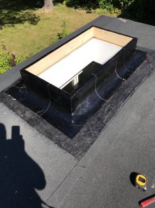 Base membrane flashing on flat roof skylight in North York