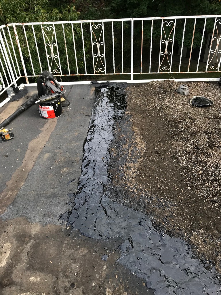 Strategic flat roof repairs on tar and gravel roof in Toronto