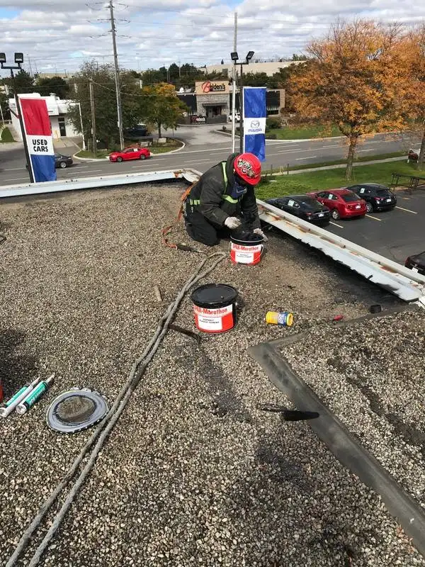Commercial flat roof repair on car dealership in Burlington