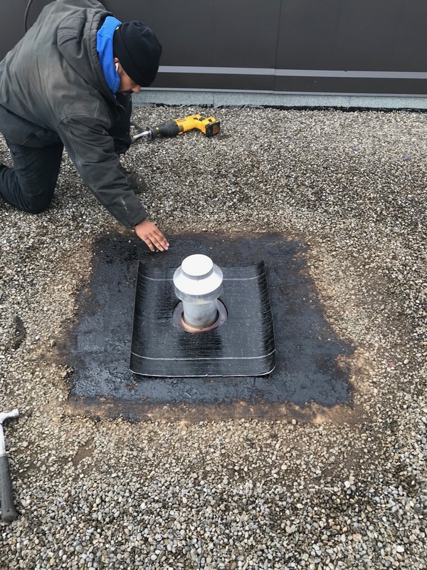 Insulated exhaust vent install on flat roof in Ajax