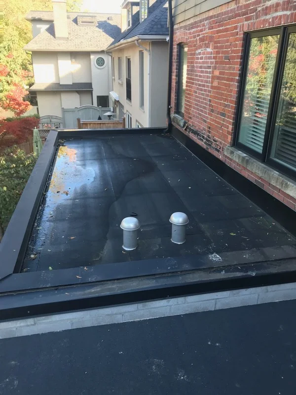 Extruded aluminum breather vents on flat roof in Toronto