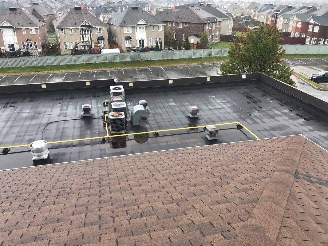 Torch applied membrane roofing system on flat roof in Ajax