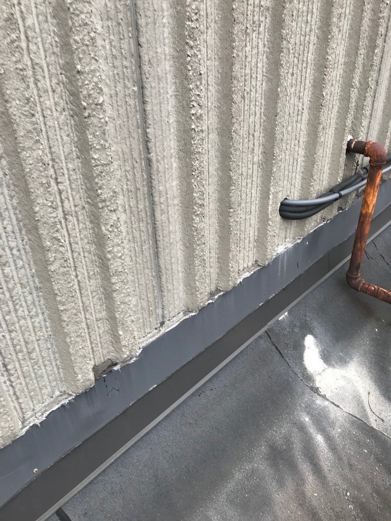 Sheet metal flashing at precast wall on flat roof in Etobicoke