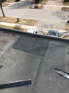 Torch applied Sopralene Flam 250 cap sheet repairs on flat roof in Toronto