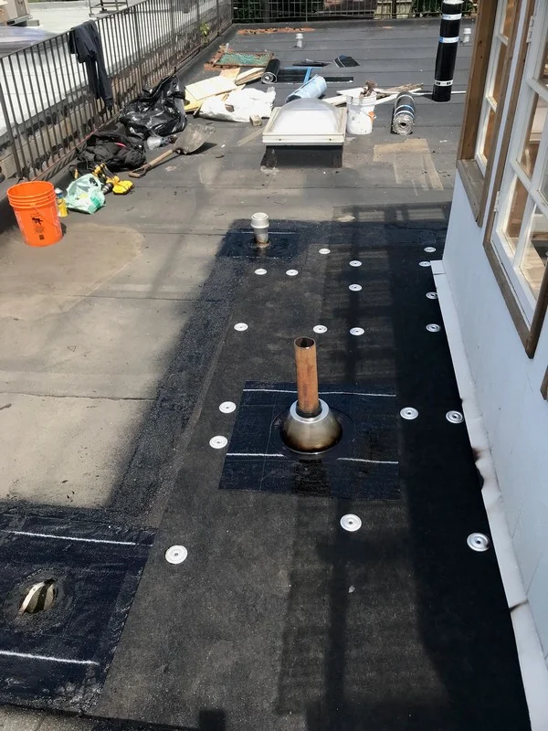 Install of Fiberglas protection board to slope flat roof on property in Toronto