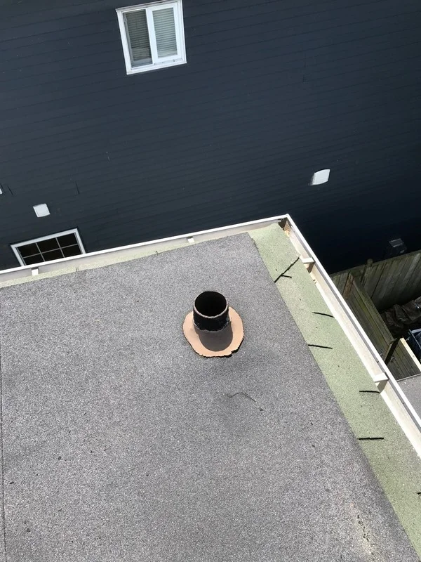 Roof repairs at cast iron plumbing pipe on flat roof in Scarborough
