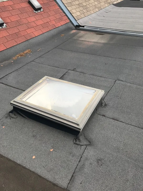Skylight repairs on modified flat roof system in Toronto
