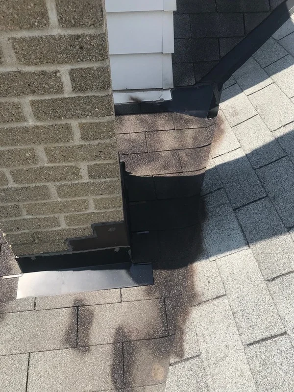 Roof repairs at chimney low slope roof in Toronto